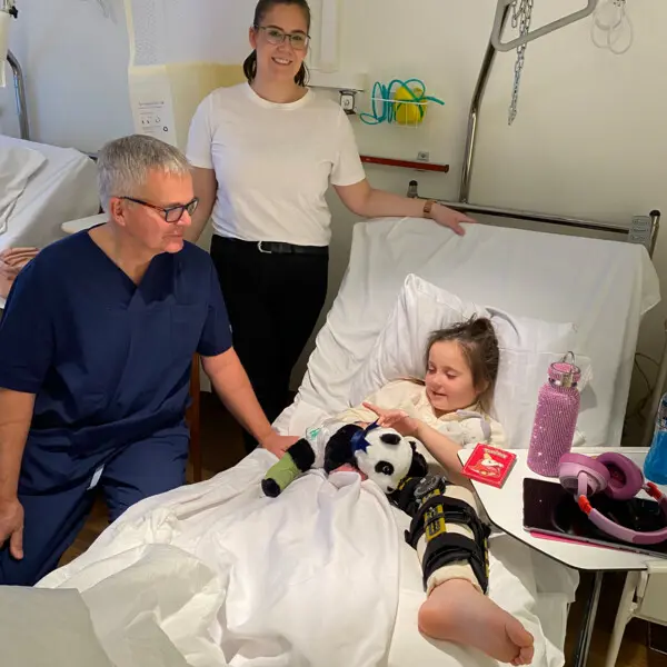 Little girl in hospital bed after ACL surgery